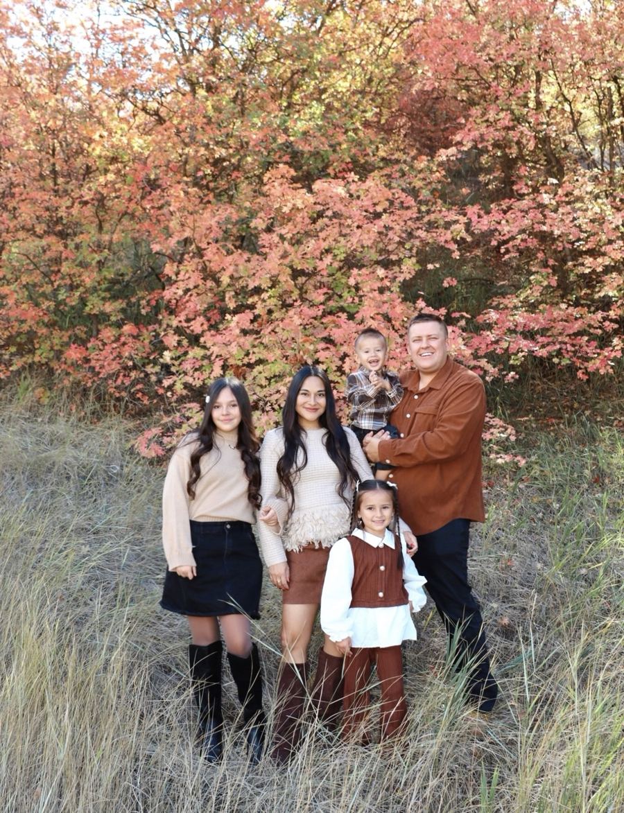 The owner with his family outdoors in autumn