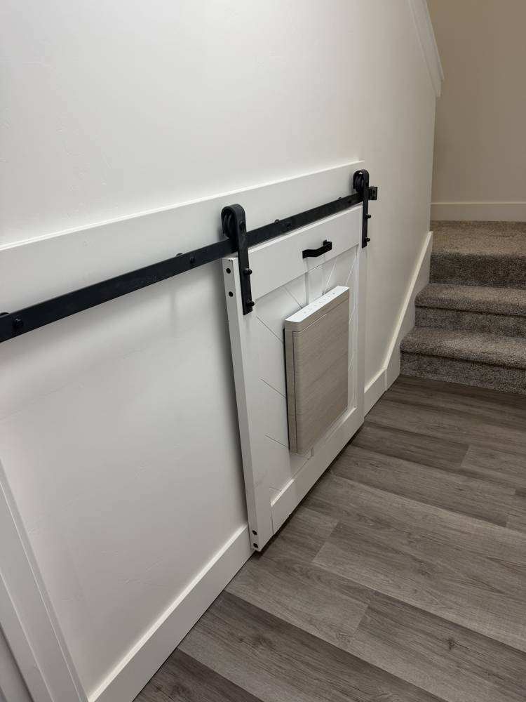 Sliding barn door built into a stair wall