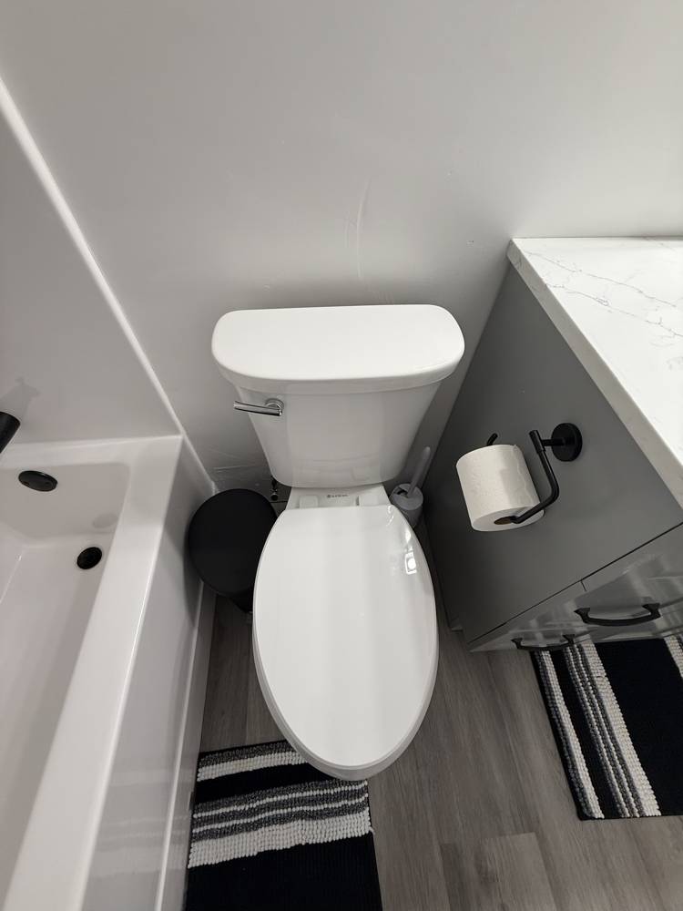 Toilet, vanity, and flooring in a finished bathroom