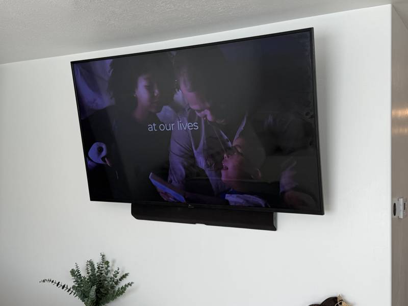 Wall-mounted TV with soundbar